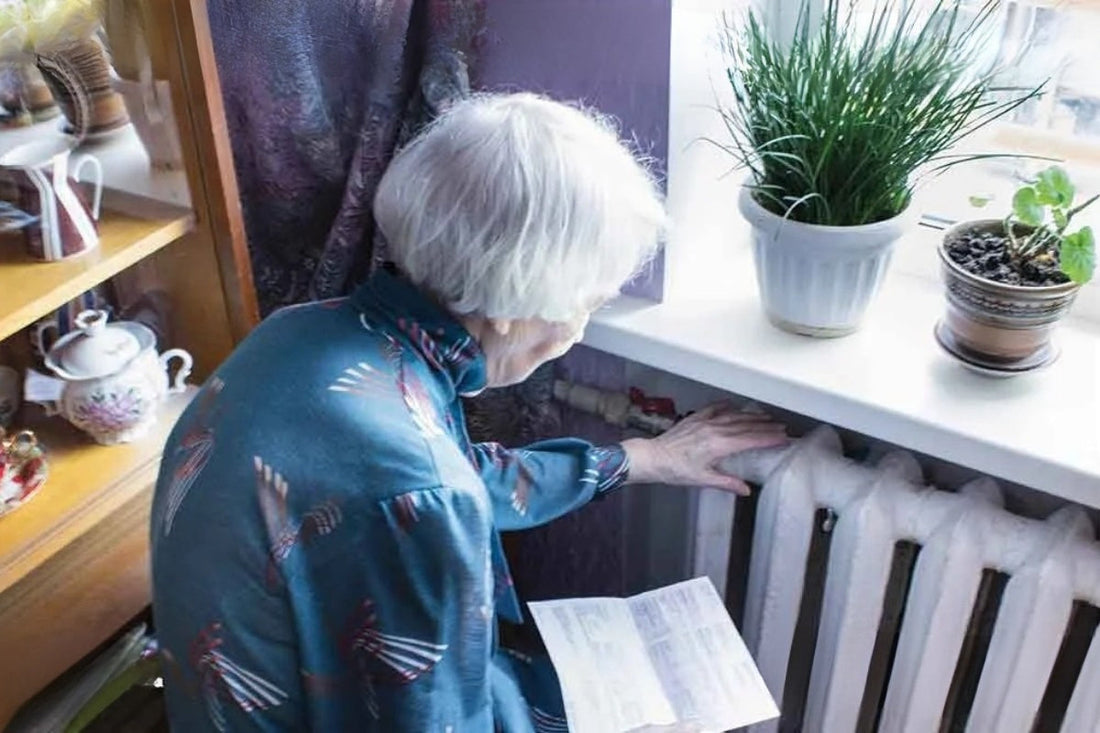 A person reaches out to touch their radiator.