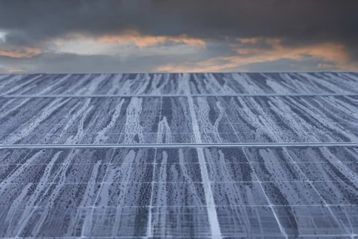 Rain drops trickle down solar panels.