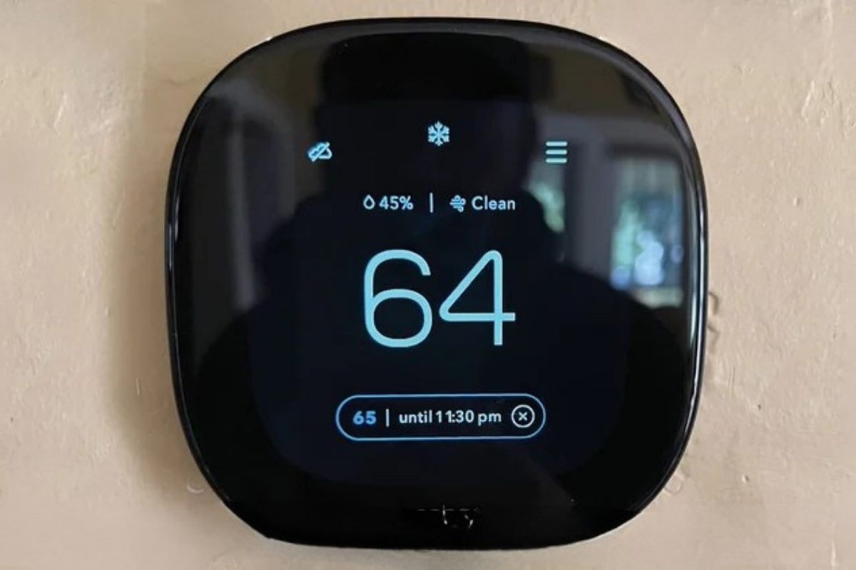 A smart thermostat mounted on a wall by ecobee.