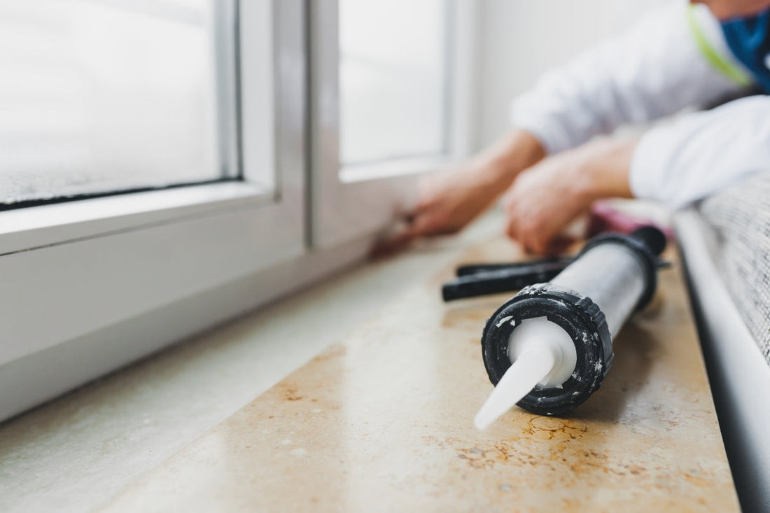 Someone seals the draft in their windows with caulking.