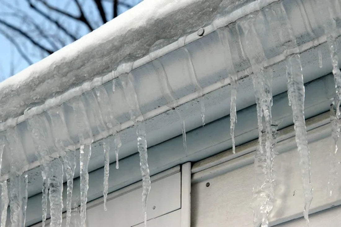 Icicles and snow sit on the edge of the roof.