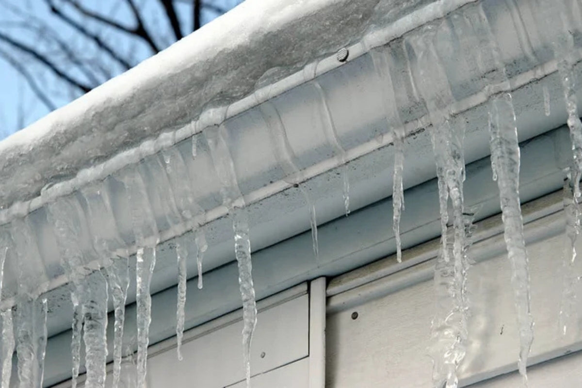 Icicles and snow sit on the edge of the roof.